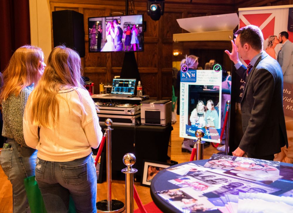 people at the united at the union wedding expo exploring a DJ booth