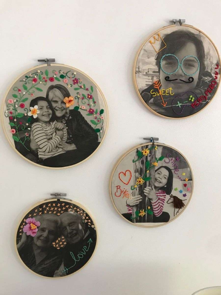 4 embroidery hoops each with a different black and white photo decorated with colorful embroidery