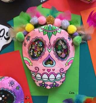 pink sugar skull made out of paper, sequins, and pom poms