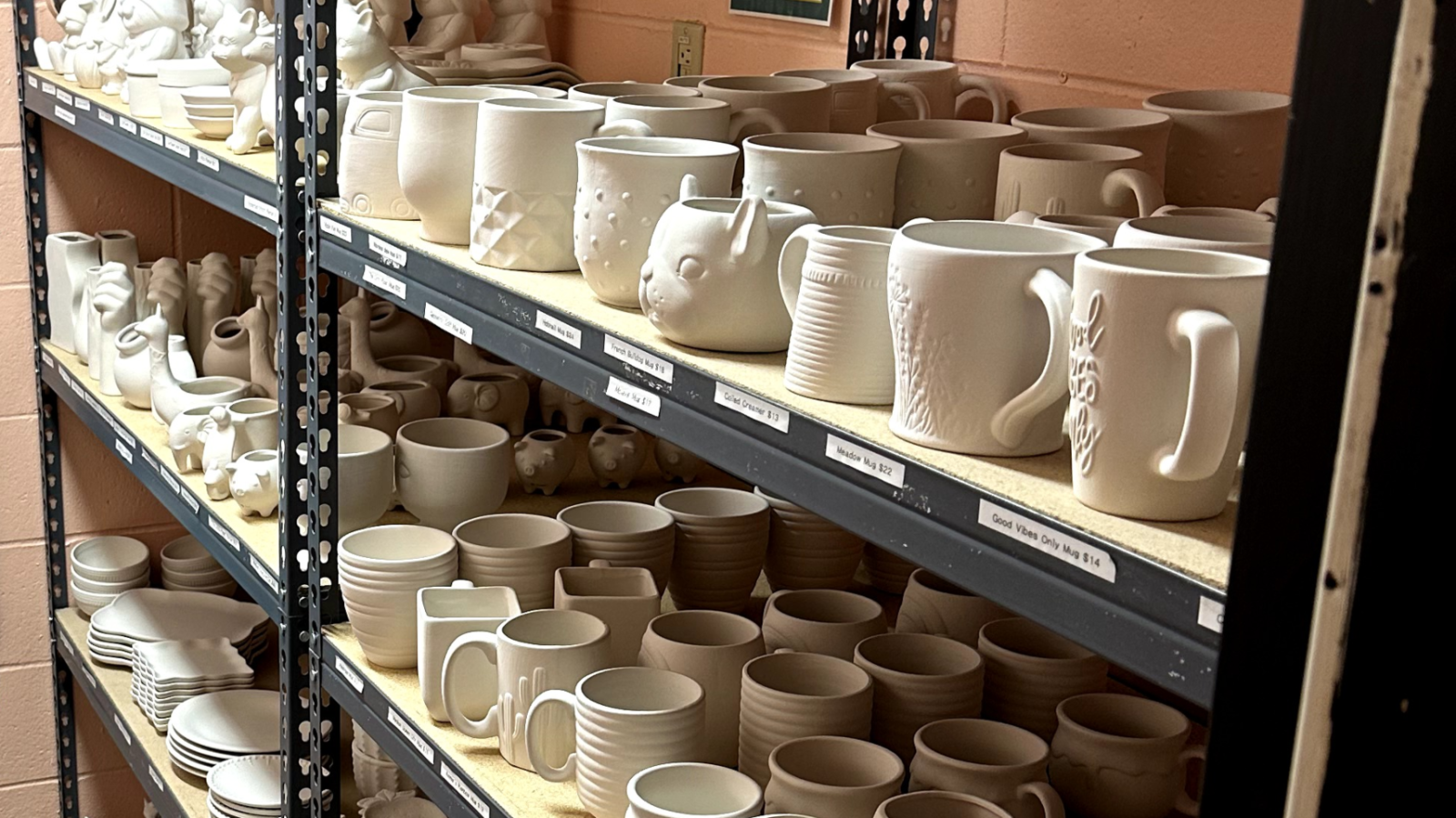 picture of unpainted bisque items lined up on shelves in the Workspace
